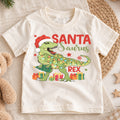 Santasaurus Rex Kids Christmas Shirt, T Rex Santa Dinosaur Tee, Funny Holiday Dino T Shirt, Christmas Gift for Kids — product view 1